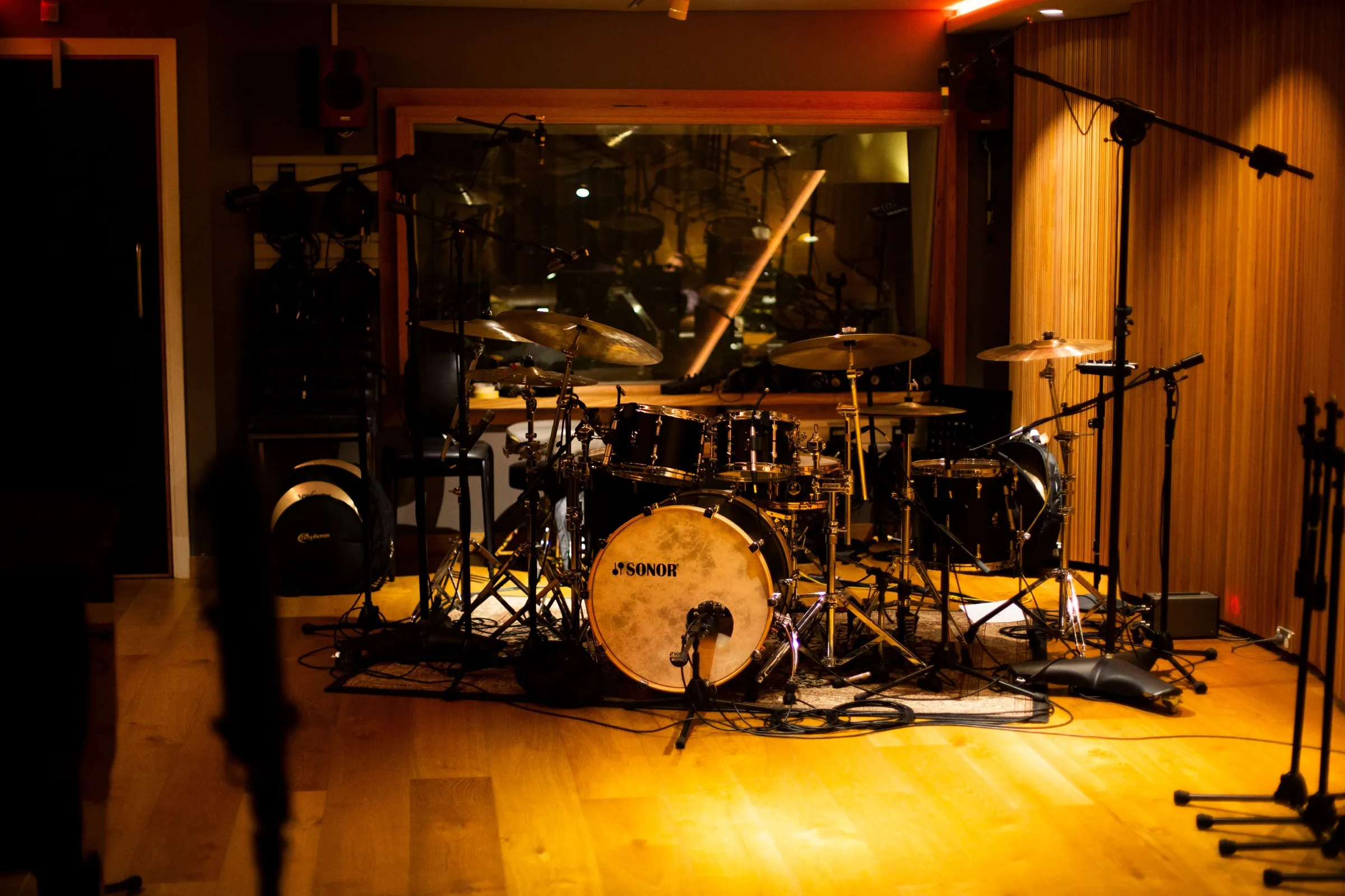 A Sonor kit fully mic'd and ready in the amber-lit live room