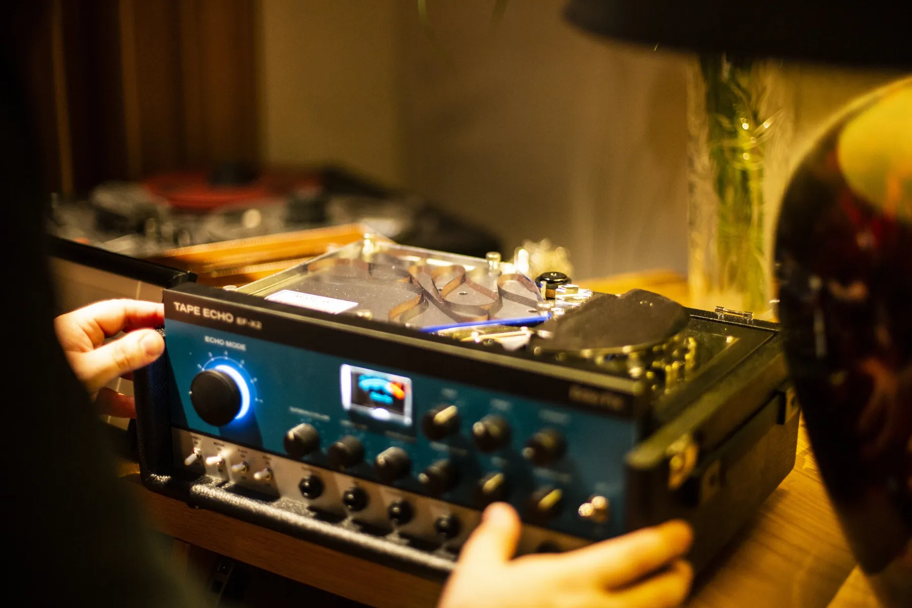 A Roland Space Echo tape unit glowing blue at A Sharp