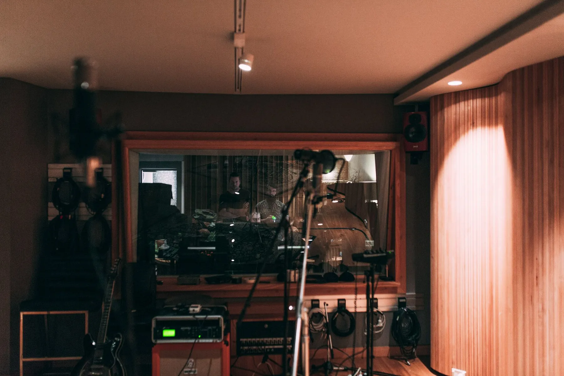 The live room cable wall and the window through to the control room